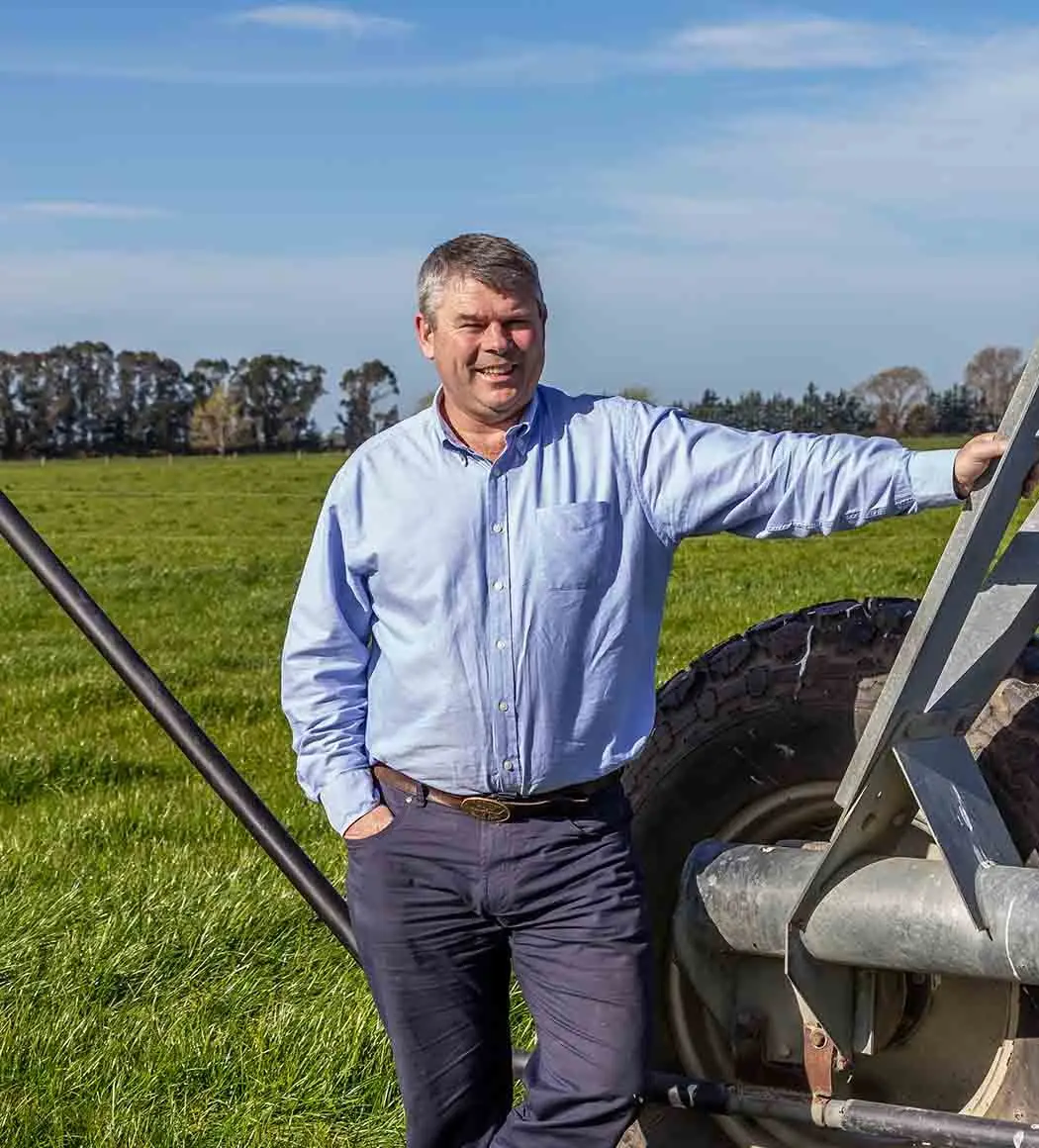 Graeme Pile, owner of Fertigation Systems, leaning on a centre pivot in a paddock